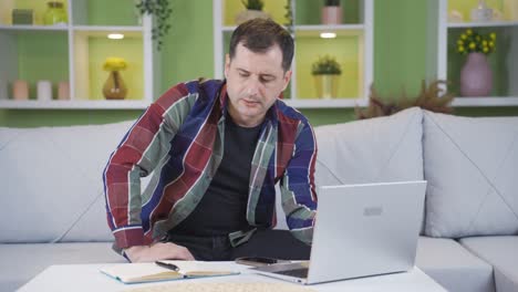 Unhappy-and-thoughtful-man-pauses-and-keeps-thinking-while-working-from-home.